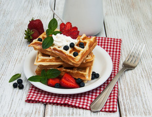 waffles with strawberries,  blueberry and milk