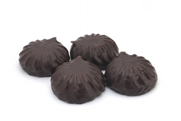 chocolate covered marshmallows, part of one bitten off, isolated on white background