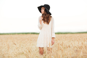 Beautiful young girl with long hair and hat posing