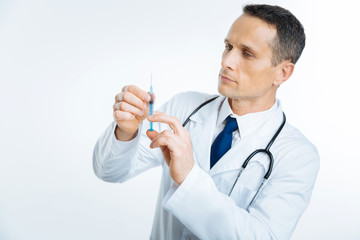 Medical professional checking syringe before vaccination