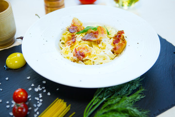 Pasta Carbonara. Spaghetti with bacon and parmesan cheese on dark background