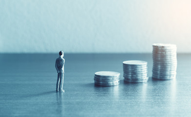 Miniature people standing with looking stack coin about financial and future  money savings concept.