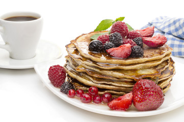 Delicious pancakes with berries and maple syrup