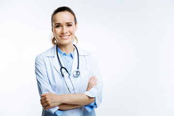 Beautiful female doctor smiling into camera