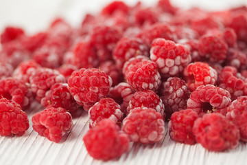 Raspberries in a frost on a light background
