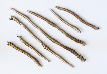 A beautiful metal strand on a light background. Metalworks details.