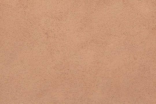 Brown painted stucco wall. Background texture