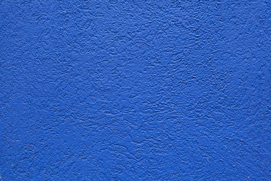Blue painted stucco wall.