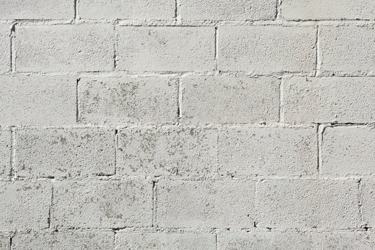 Whitewashed brick wall.