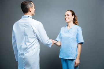Friendly medical professionals shaking hands