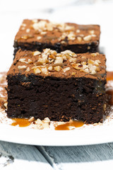 dessert - pieces of chocolate brownies with caramel sauce, vertical