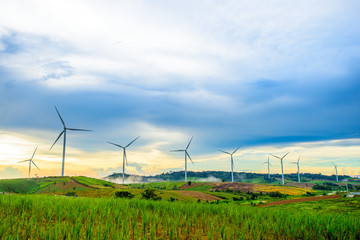 Beautiful fog mountain landscape and wind generators turbines at sunset, Khao Kho mountain,...
