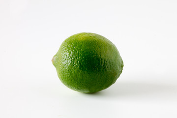 Lime isolated on white background, side photo