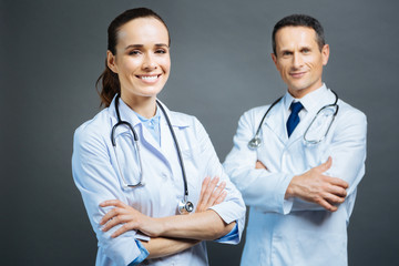 Friendly looking female doctor posing with hands crossed