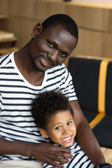 african american father and child hugging