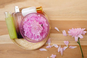 Skin cream, shampoo, salt spa and flower On a wooden background. Spa Concept.