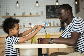 Fototapeta na wymiar happy father and son in cafe