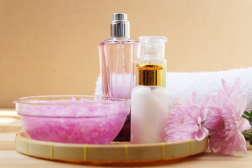 Obraz na płótnie Canvas Skin cream, shampoo, salt spa and flower On a wooden background. Spa Concept.
