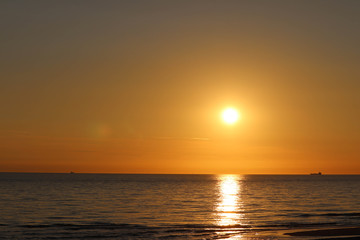 Obraz premium Sunset on beach Maasvlakte, port of Rotterdam