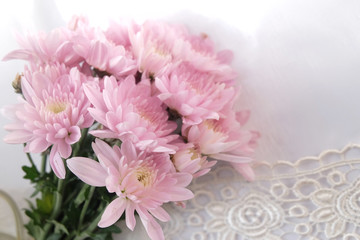 Pink flower bouquet on thin white fabric background. Wedding concept.