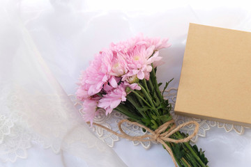 Pink flower bouquet on thin white fabric background. Wedding concept.