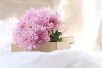 Pink flower bouquet on thin white fabric background. Wedding concept.