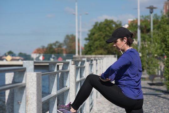 Woman Performing Stretching Exercise On Bridge