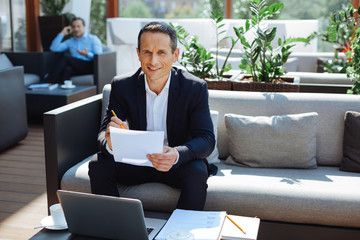 Positive cheerful man looking at you