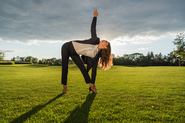 businesswoman standing in yoga pose