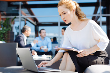 Smart pleasant businesswoman being involved in her work