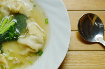 Chinese dumpling stuffed minced pork in soup and spoon