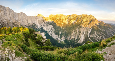 Great panoramic view to mountains and valley in sunset light with alpenglow.