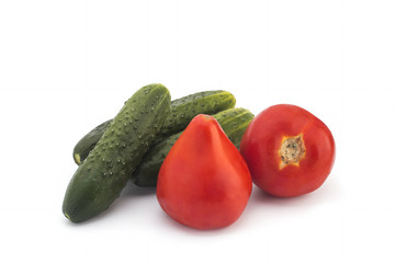 Red tomatoes and green cucumbers on a white background