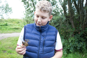 the boy in the blue waistcoat with cancer in the hand
