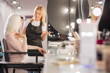 Senior lady discussing makeup ideas with her makeup artist