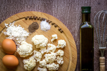 Healthy eating, vegetarian food. Raw cauliflower prepared for frying in a frying pan with spices in olive oil