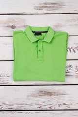 Folded men polo light green shirt.