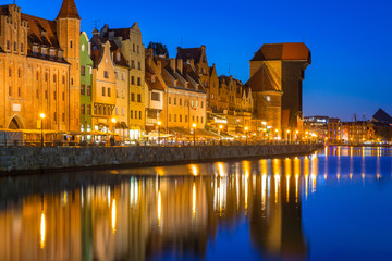 Gdansk at night with historic port crane reflected in Motlawa river, Poland