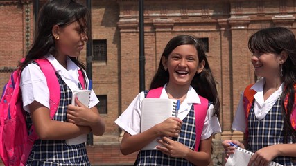 Young Colombian Girl Students Holding Notebooks Wearing School Uniforms