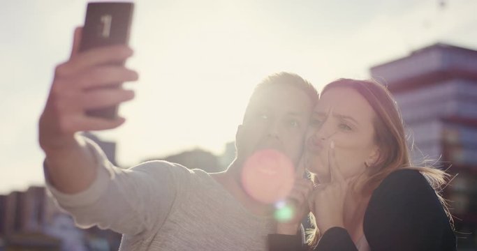 Cute couple making silly things and faces for selfie