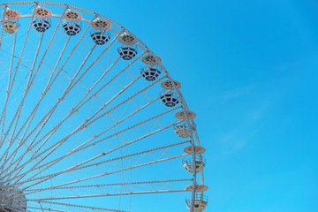 Ferris wheel on blue sky background. In the amusement Park. The weekend