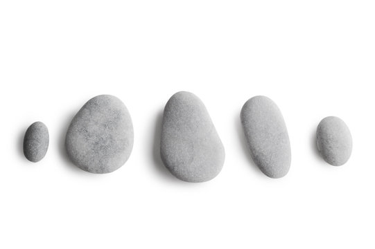Grey pebbles on white background