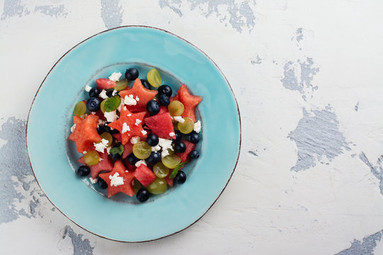 Fresh summer watermelon salad with blueberry and grapes. Copy space