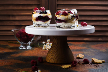 Homemade dessert in glass jars. Cheesecake, trifle, mouse on grunge stone background. Copy space
