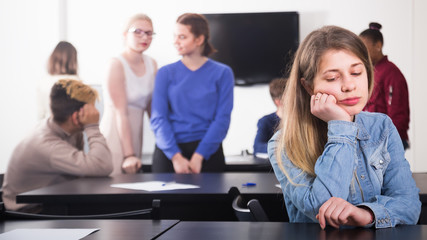 young girl student feeling uncomfortable at break between classes