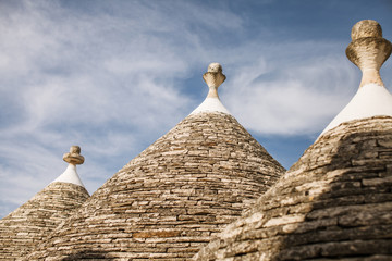 Fototapeta na wymiar Trulli houses with conical roofs in Alberobello, Italyroofs in Alberobello, Italy