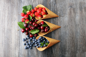 Berries in waffle cones - strawberry, blueberry and black cherry