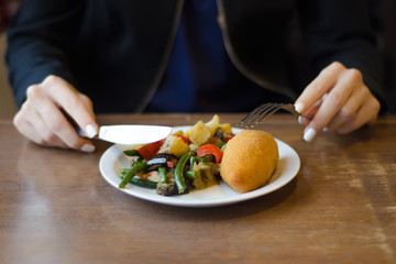 Obraz na płótnie Canvas Vegetable stew and chicken cutlet female hands