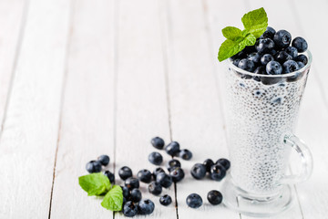 Chia pudding with berries and milk, sweet nourishing dessert, healthy breakfast superfood concept