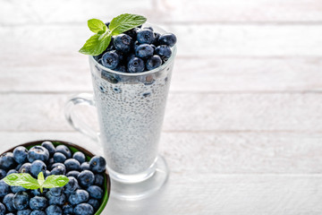 Chia pudding with berries and milk, sweet nourishing dessert, healthy breakfast superfood concept
